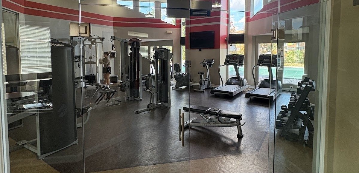 Frameless glass entry doors installed at a commercial fitness room