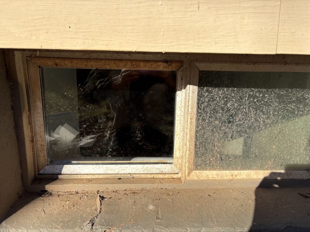 Broken basement window glass before replacement