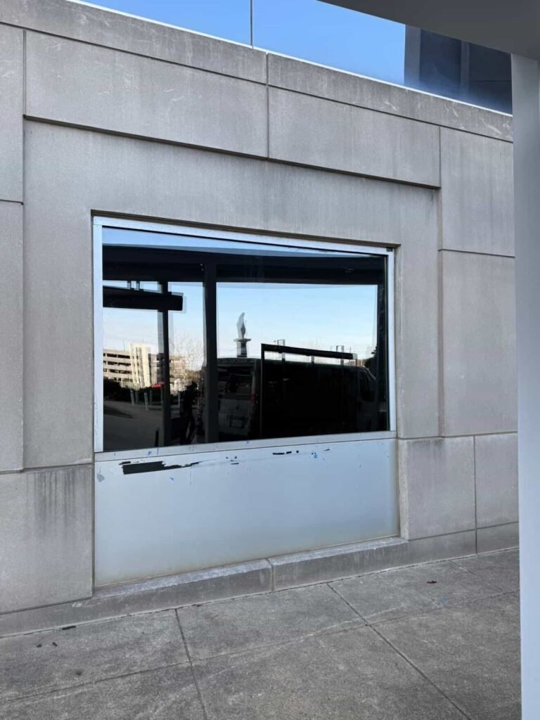 Damaged lower panel on a commercial building window