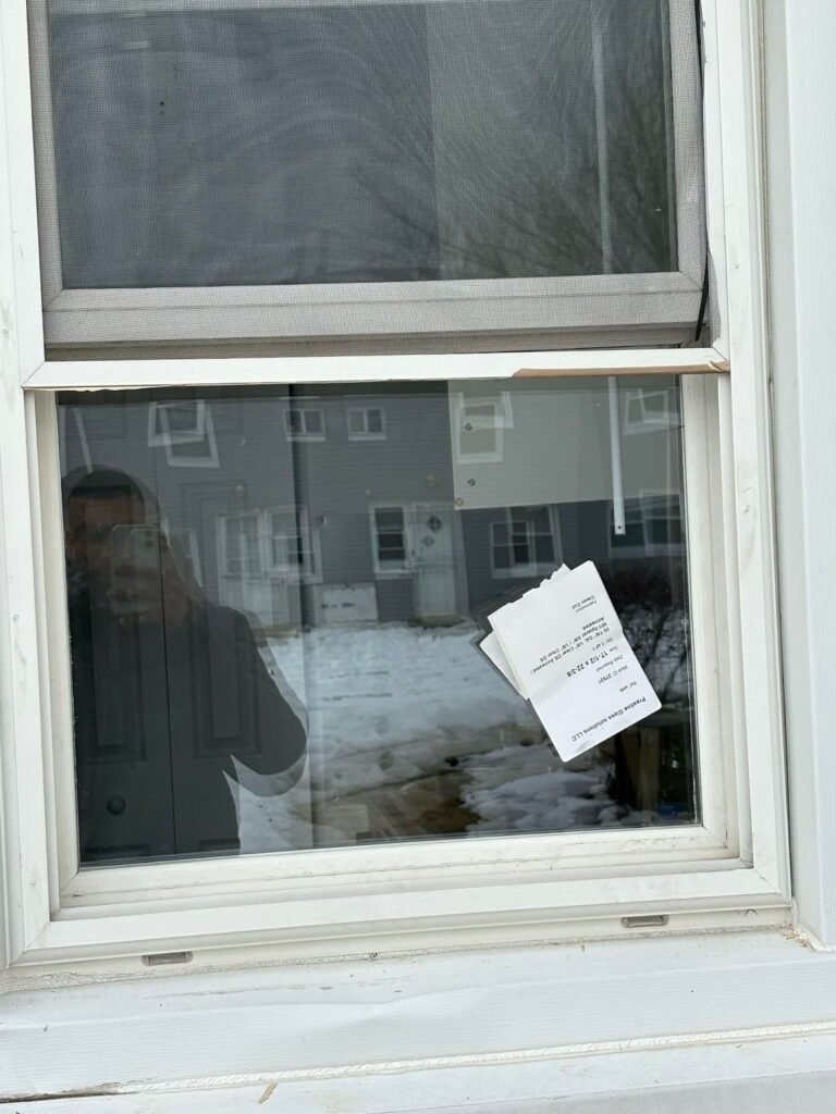 Double-hung window with a new lower glass pane and its label
