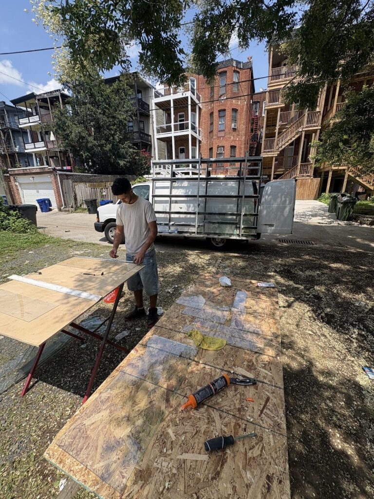 Technician cutting plywood for an emergency board-up
