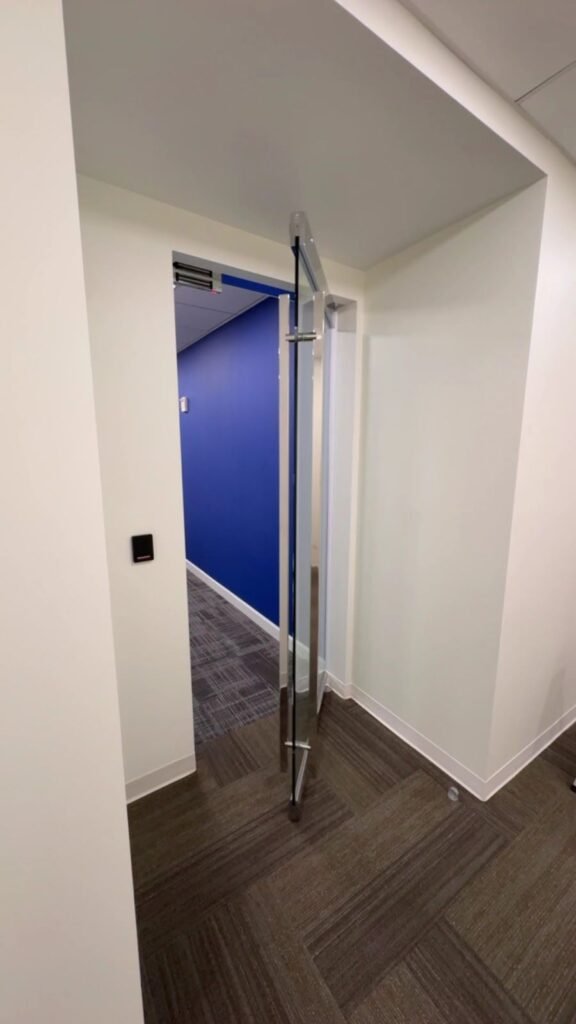Frameless glass door at an office hallway