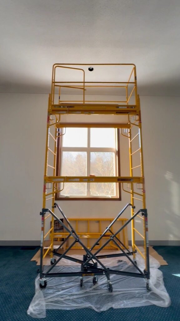 Rolling scaffold set up to replace a tall window